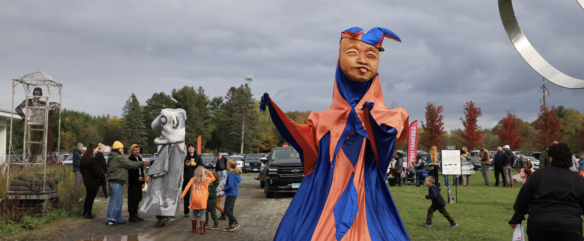 Large scale puppets interacting with visitors outside at Franconia Sculpture Park